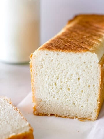 Sourdough sandwich bread made in a pullman pan, also known as pain de mie, that is sliced to show the tight crumb.
