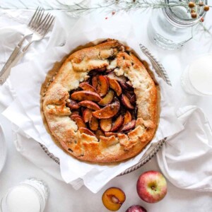 A galette top view garnished with apples.