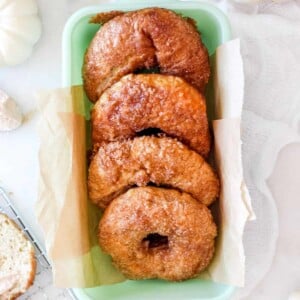 A jadeite loaf pan with panera copycat cinnamon crunch bagels.