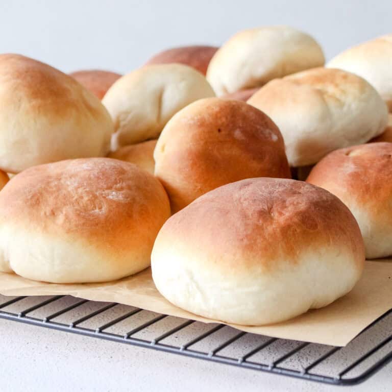 A pile of pizza pockets on a cooling rack.