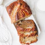 Sourdough banana bread sliced on a white platter.