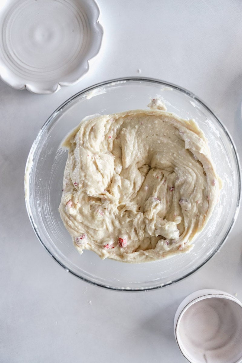 Step 3 of making fluffy strawberry cake donuts is Stir the wet ingredients into the flour mixture and mix until just combined to make the doughnut batter. Fold in the strawberry pieces. 