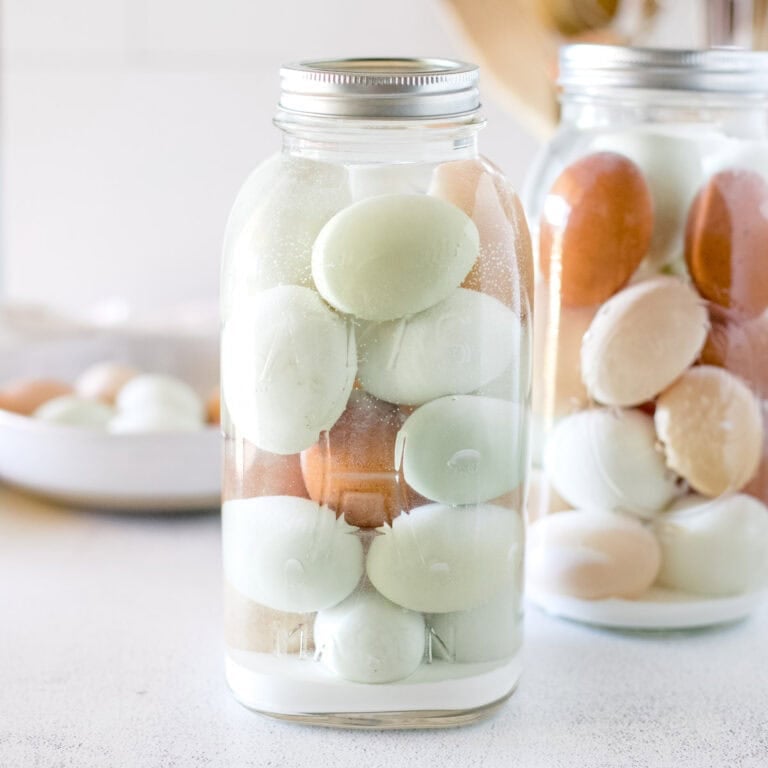 A half gallon mason jar filled with water glassed eggs for preserving.