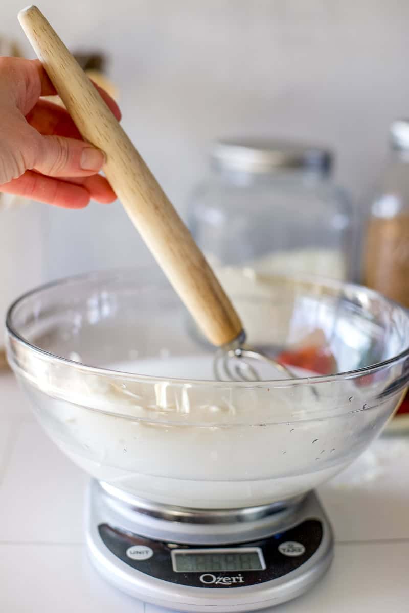 Step 1 of making sourdough dinner rolls is combining the ingredients in a mixing bowl.