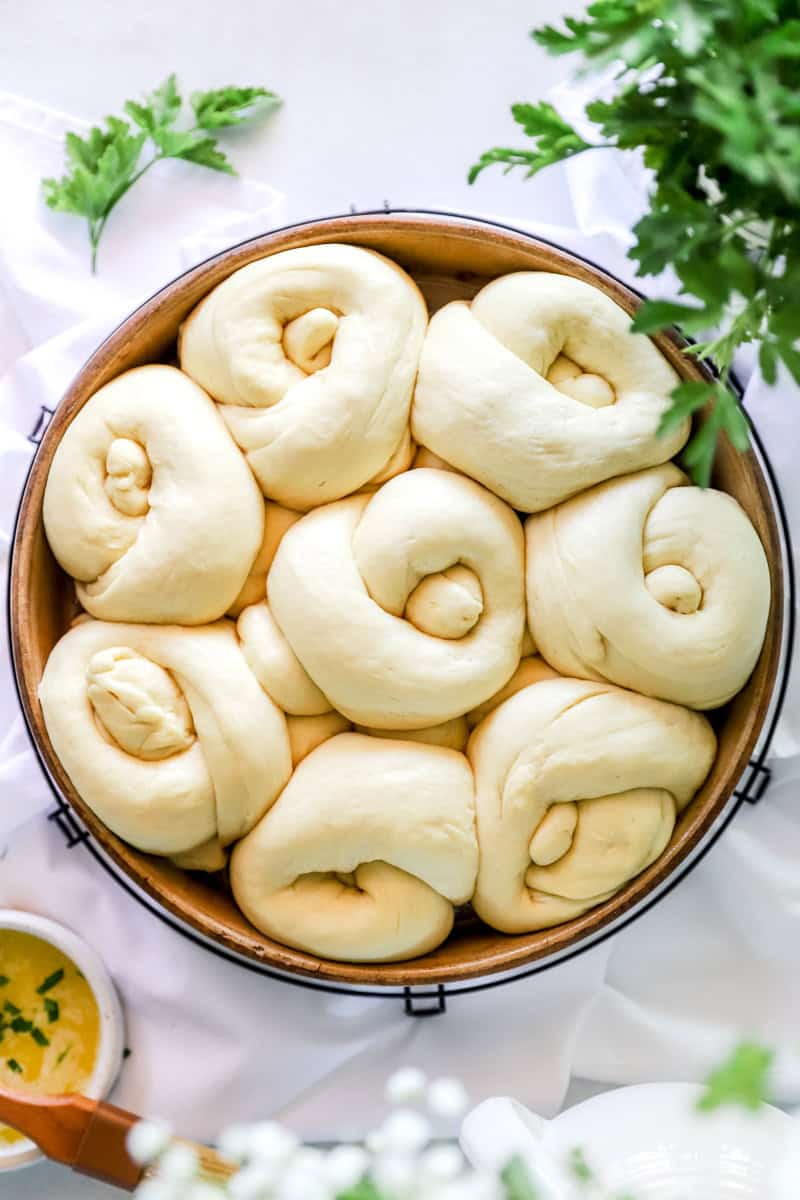 Cover the unbaked knots with aluminum foil, plastic wrap and put the rolls in the refrigerator overnight to bulk rise for 8-12 hours or even longer!