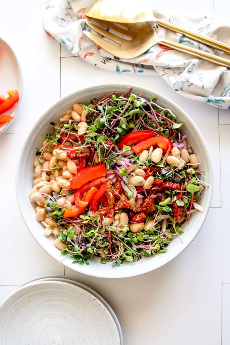 Step 3 of making cannellini bean salad is  Toss to combine.