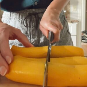 Slicing yellow squash for a blog post explaining how to roast zucchini and yellow squash.