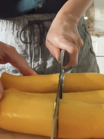 Slicing yellow squash for a blog post explaining how to roast zucchini and yellow squash.