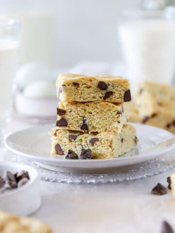 Side view of sourdough blondies stacked 3 high on a plate.