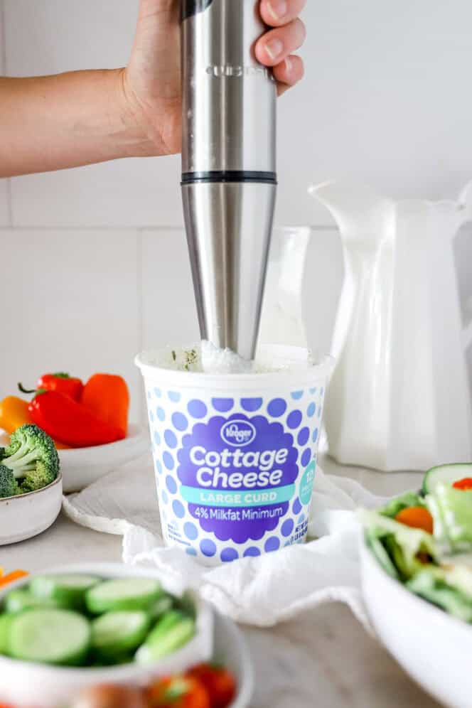 Step 2 of making ranch mix cottage cheese dip is using a blender to blend the mixture until smooth.