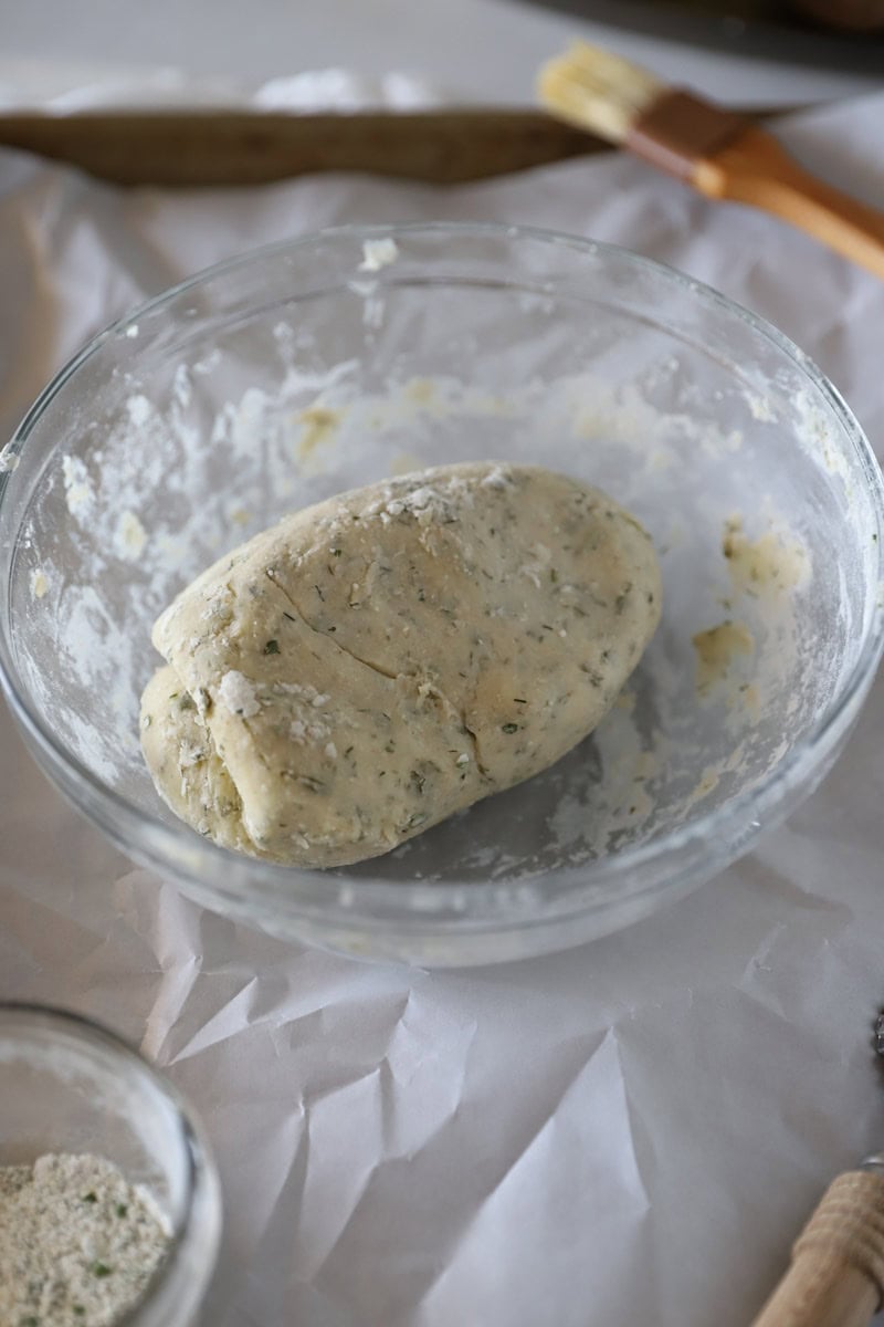 Step 1 In a large bowl, combine the flour, sourdough starter, ranch seasoning, melted butter and salt.  Start by using a wooden spoon, then use your hands to work the dough into a ball.  It will start out messy, but once the ingredients blend, it will be a soft and pliable dough. Flatten the ball into a rectangular disc.
