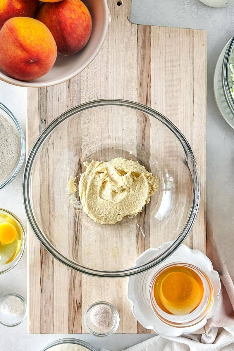 Step 3 of peach quick bread is whipping the sugar and butter in a bowl.