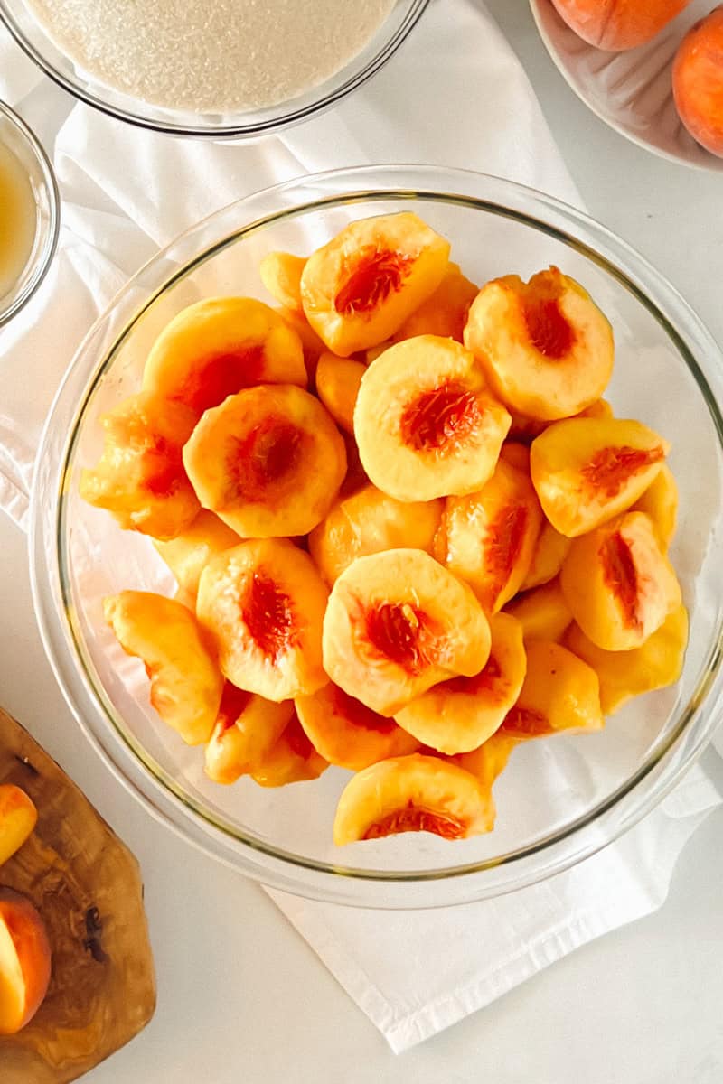 Step 1 of making peach preserves is pealing and pitting the peaches.