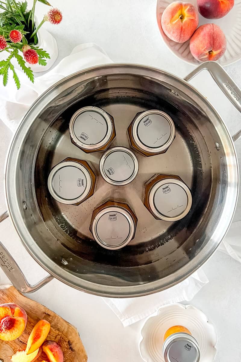Step 6 Place filled jars in a water bath canner, ensuring jars are covered by at least 1 inch of water. 