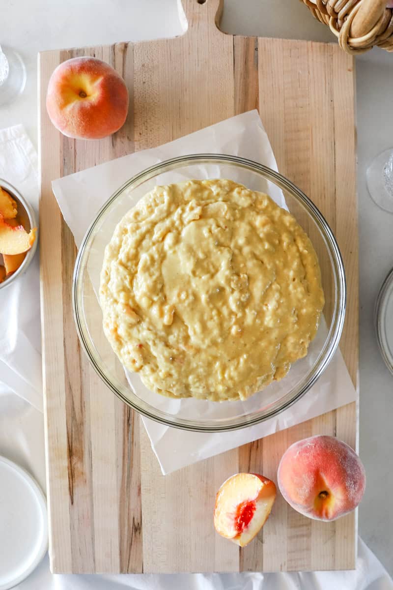 Step 5 of making sourdough peach quick bread is stirring in the sourdough starter.