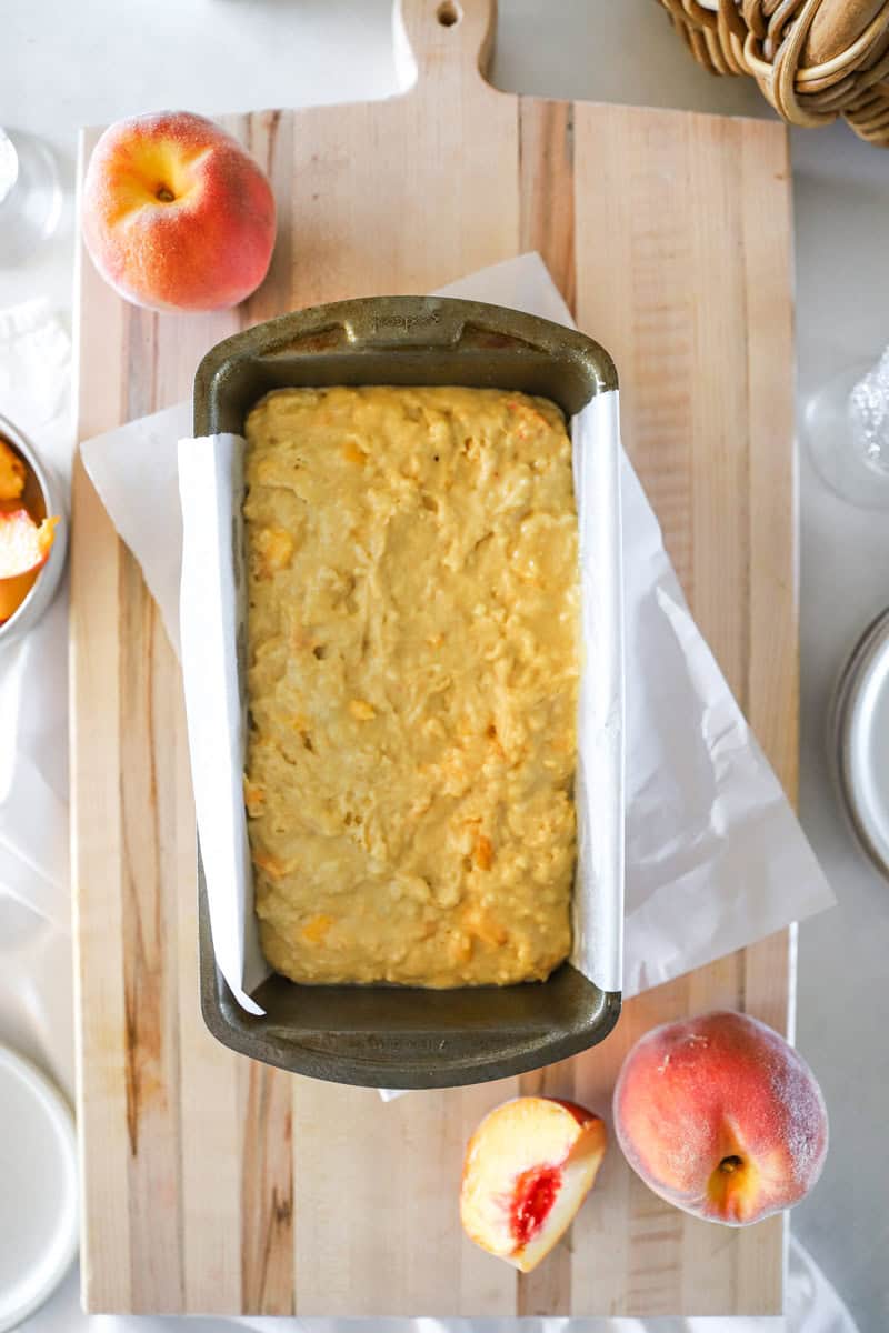 Step 7 of making peach quick bread is pour into loaf pan and bake for about 60 minutes, or until the internal temperature at the center of the bread reaches 200°F with a thermometer.