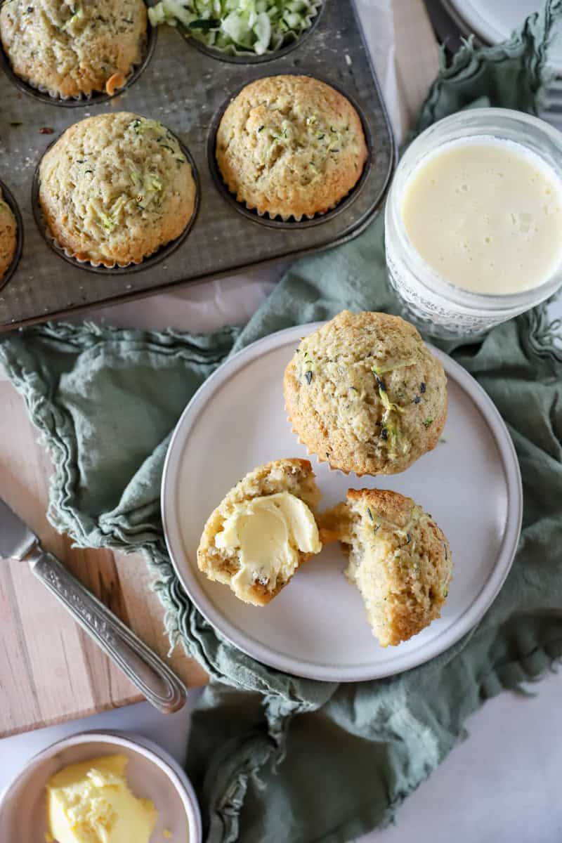 Banana zucchini muffins, top view, sliced with butter.