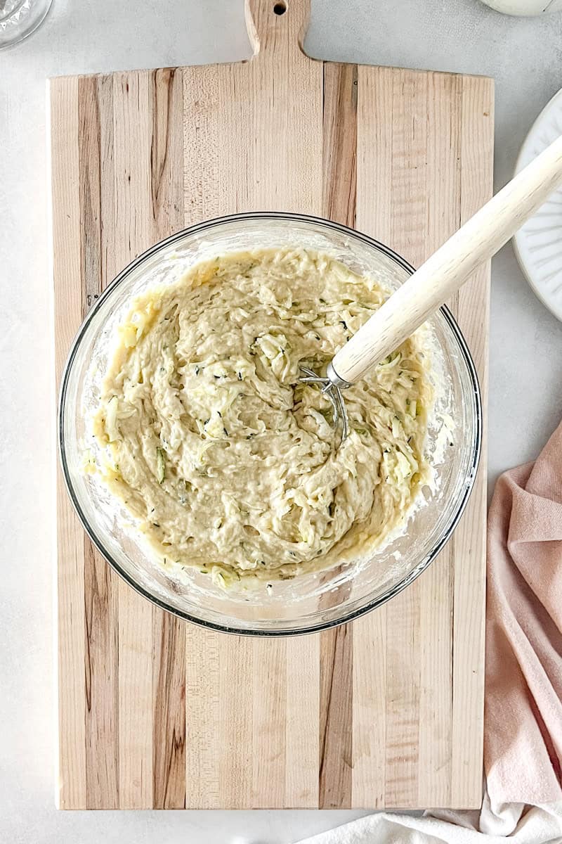Step 6 Slowly fold in the dry ingredients and zucchini, mix the muffin batter until just combined.