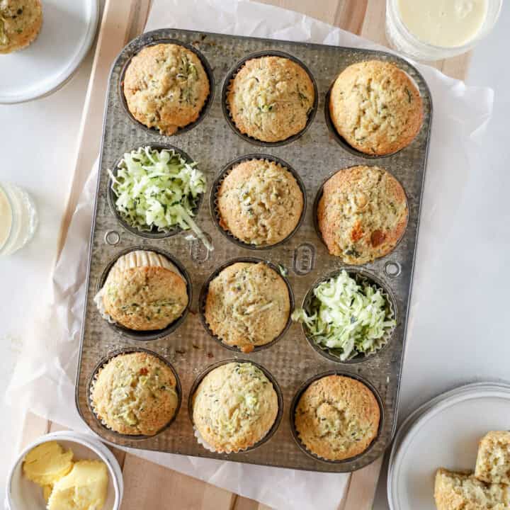 A top view of zucchini banana muffins in a muffin pan.