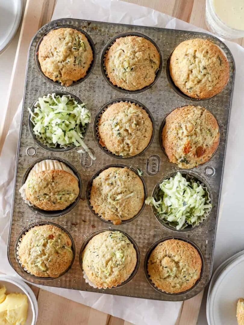 A top view of zucchini banana muffins in a muffin pan.