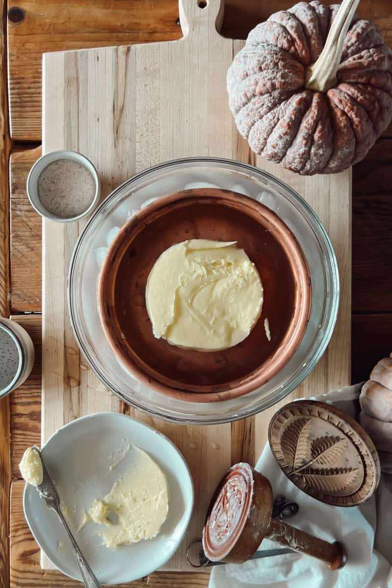Helpful tools for making homemade butter: bowl, press, strainer, etc.
