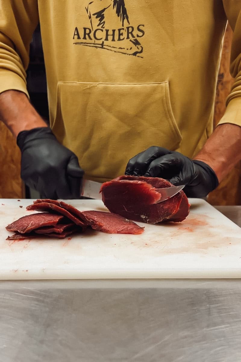 Step 2 of making deer jerky is putting the thinly sliced meat into the marinade.