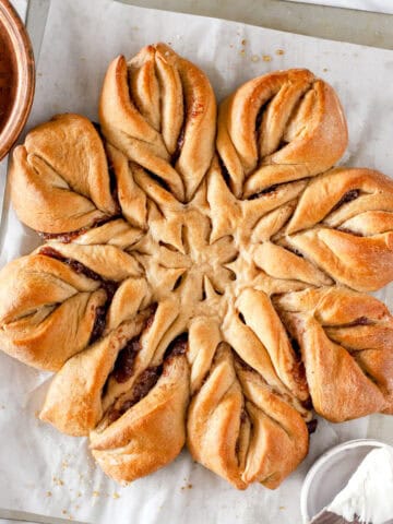 Christmas Star bread on parchment paper and a baking sheet, top view.