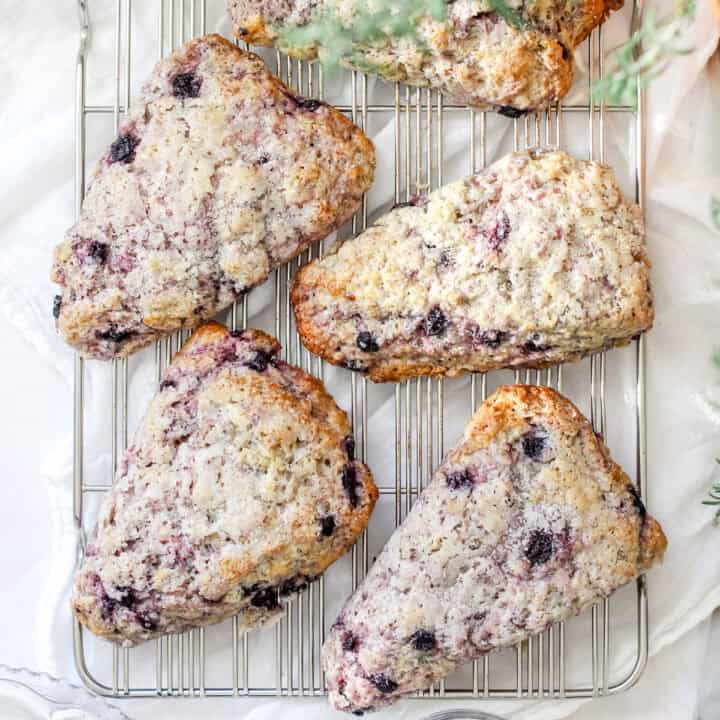 A top view of blueberry sourdough scones on a cooling rack.