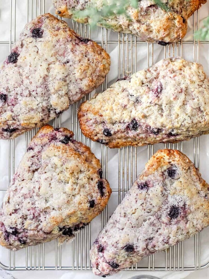 A top view of blueberry sourdough scones on a cooling rack.