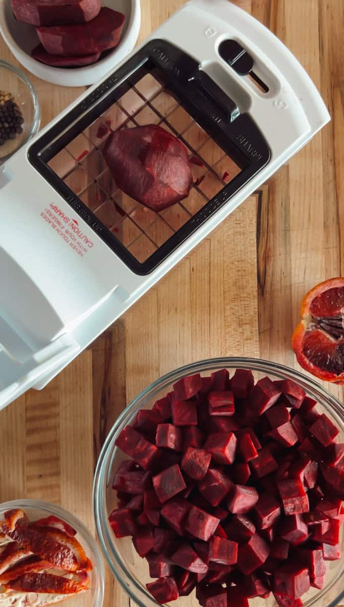 Slice the beets into small pieces, either half-inch slices or quarters, depending on the size, I'm using a food chopper.
