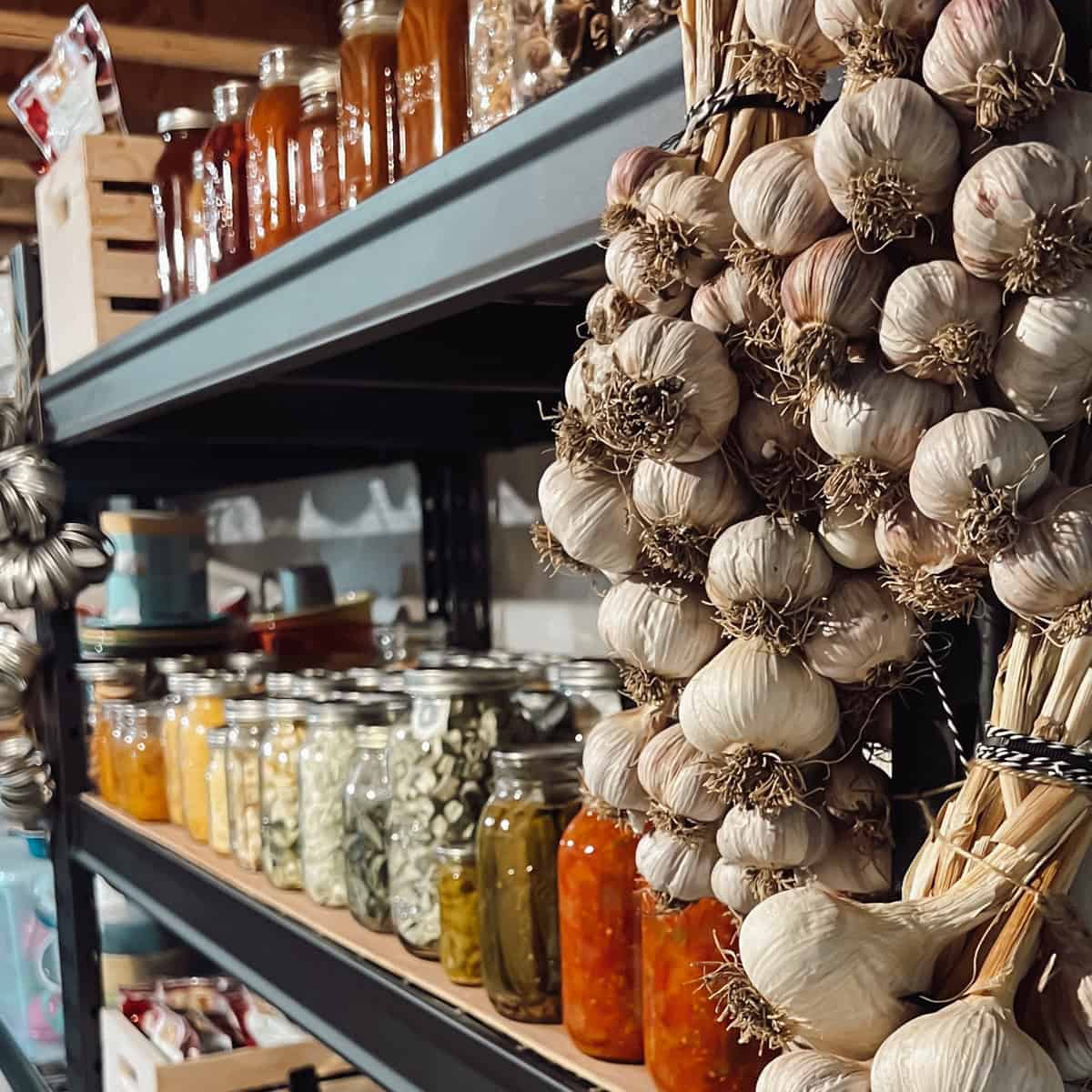 Pantry shelf stocked with jars of preserved food.