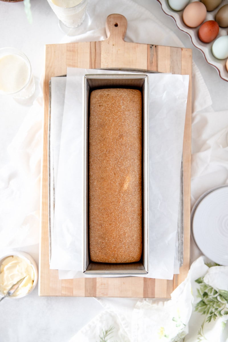 A top view of fresh baked whole wheat sourdough sandwich bread in a pullman pan.