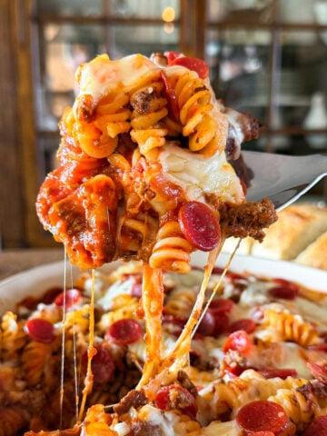 Cheesy pizza pasta bake made with ground beef or venison, rotini pasta, pepperoni, pizza sauce, and melted mozzarella cheese.