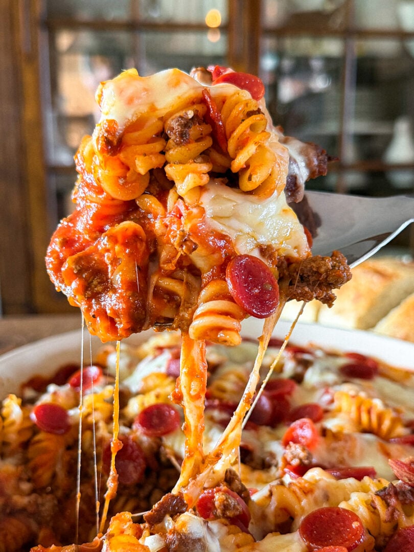 Cheesy pizza pasta bake made with ground beef or venison, rotini pasta, pepperoni, pizza sauce, and melted mozzarella cheese.