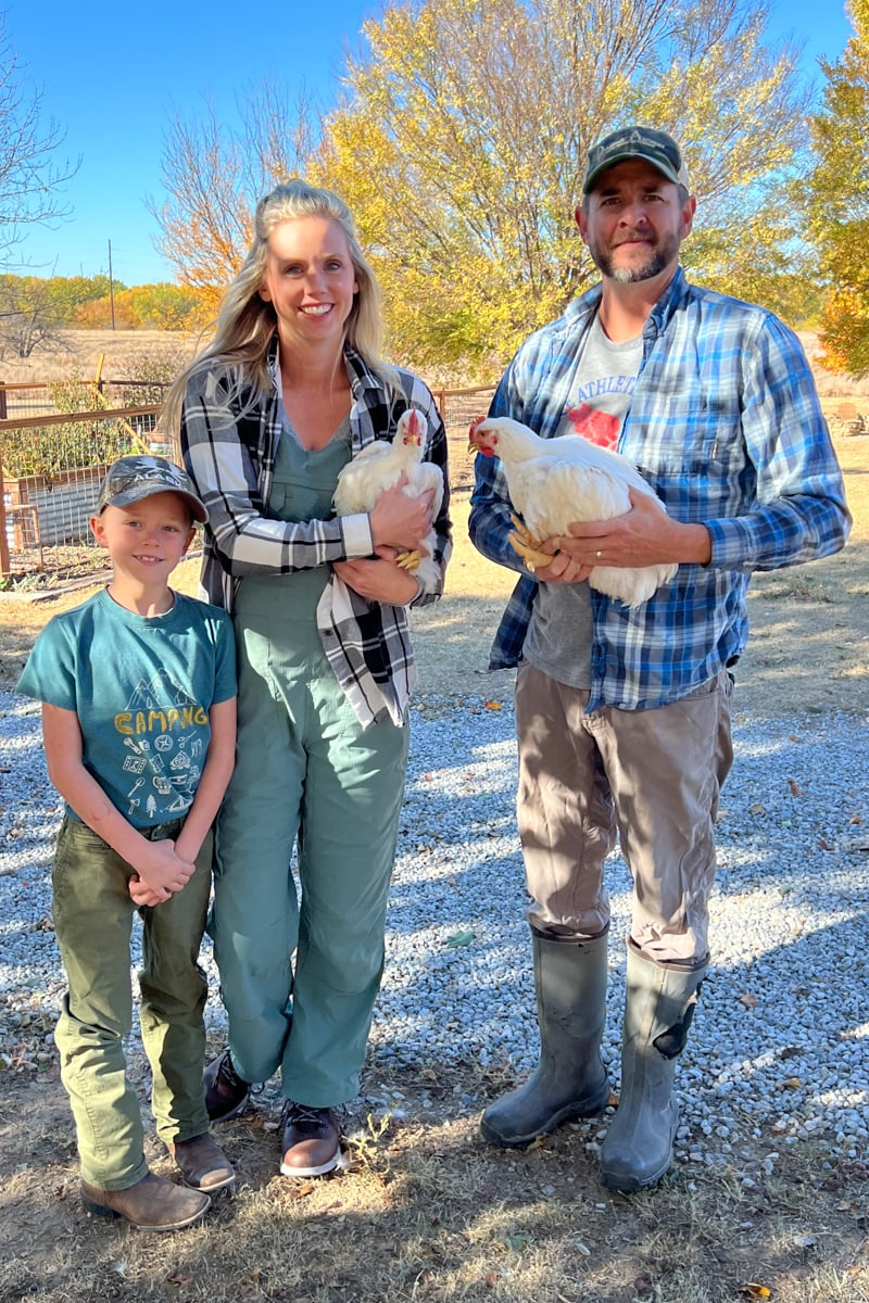 The Austin family holding cornish cross chickens to process for meat.