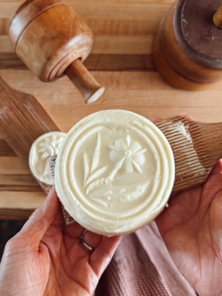 Finished molded butter with a detailed flower design made using an antique wooden butter mold