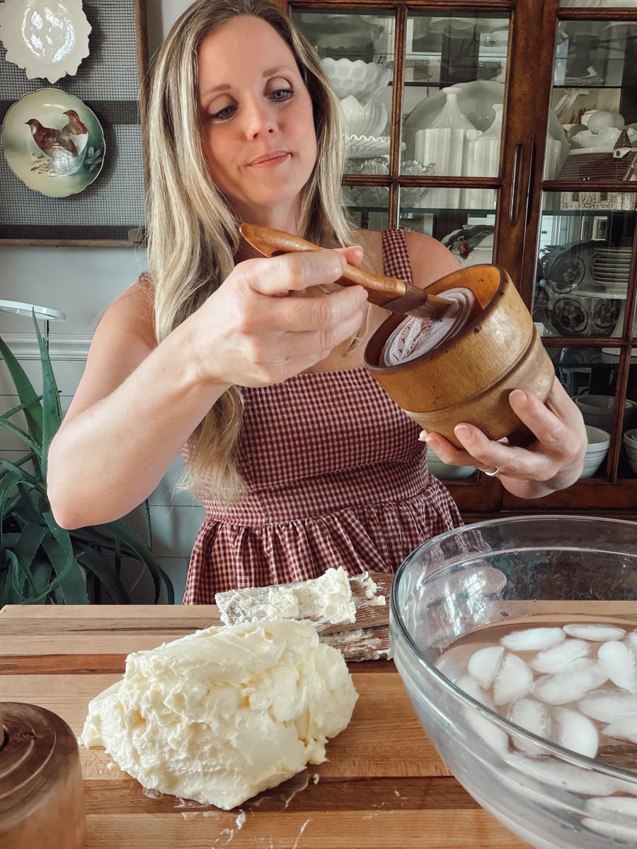 Cleaning an antique butter mold and brushing on a thin coat of oil before pressing butter.