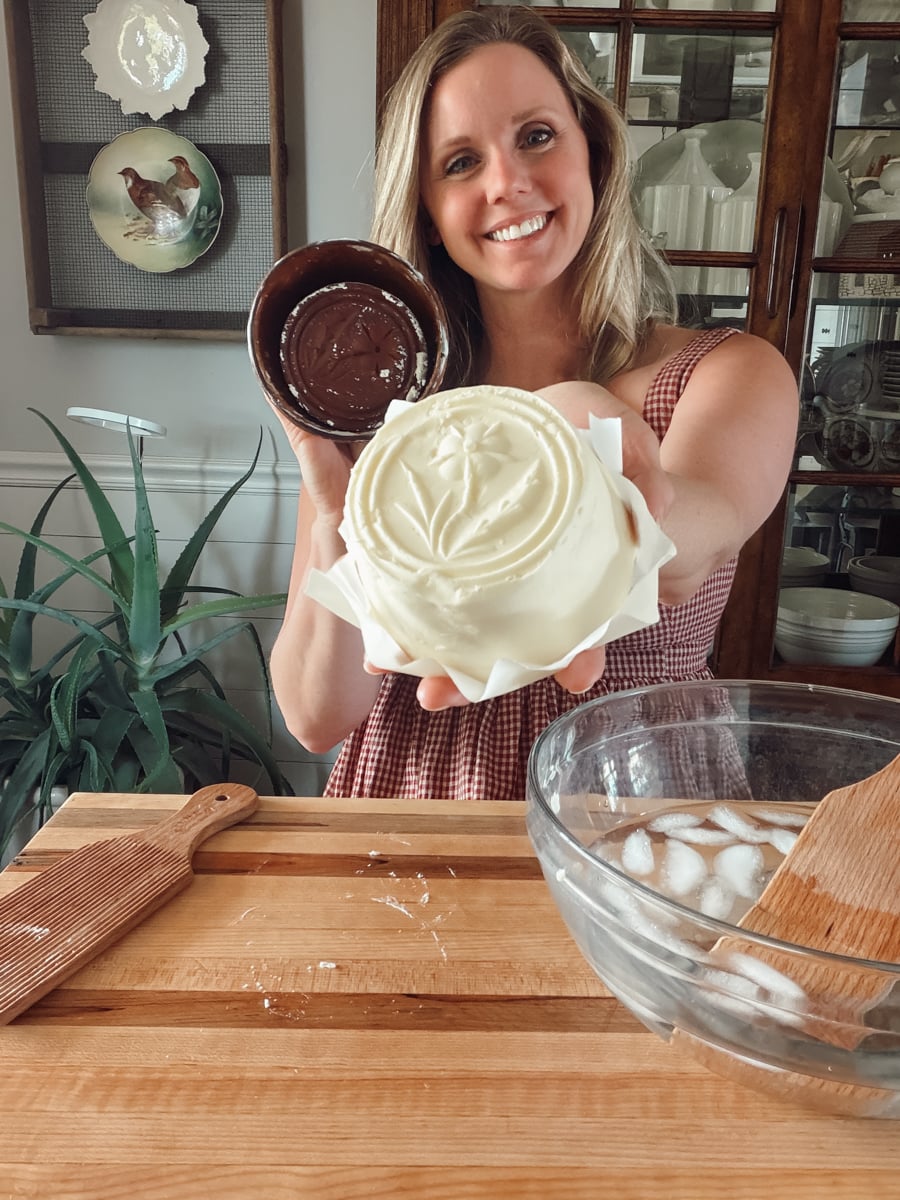 Finished molded butter with a detailed flower design made using an antique wooden butter mold.